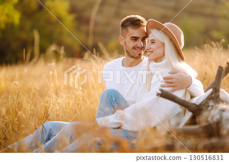 Young couple having fun walking and hugging n the park. Autumn weather. Relaxation, youth. 130516831