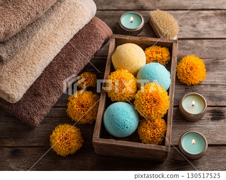 Spa arrangement with colorful bath bombs, fresh marigold flowers 130517525