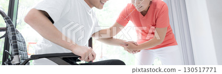 Beautiful fresh greenery by the window, medical staff and a patient in a wheelchair, rehabilitation image, faceless banner Beautiful fresh greenery by the window, medical staff and a patient in a wheelchair, rehabilitation image, faceless banner 130517771