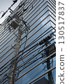 A jumble of utility poles and buildings 130517837