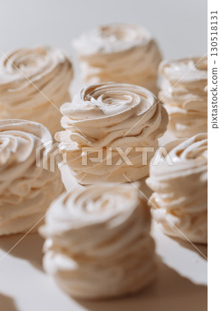 Soft vanilla marshmallow dessert in natural light with airy texture and spiral shape 130518131