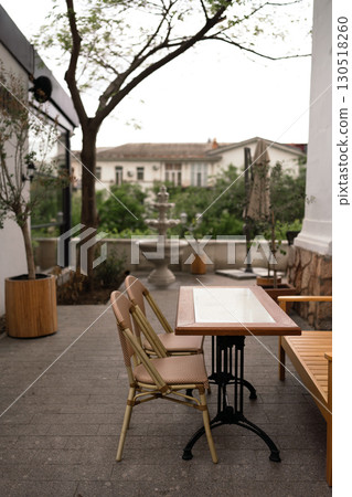 Restaurant Table Chairs outdoors provides Dining at empty terrace during the daytime for customer. 130518260