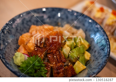 Donburi, a Japanese rice bowl dish of seafood. Including raw fish such as Salmon, Ikura, Unagi, and Avocado Donburi, a Japanese rice bowl dish of seafood. Including raw fish such as Salmon, Ikura, Unagi, and Avocado 130518287