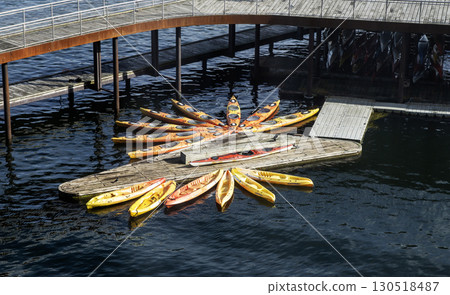 Colorful Kayaks Arranged in a Star Shape at a Waterfront Location in Copenhagen Denmark, 130518487