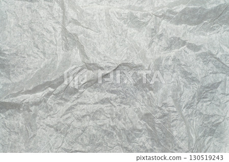 Wrinkled white package paper texture, isolated on background. Rough creased surface ideal for packaging, wrapping, crafts, scrapbooking, design, and artistic projects. 130519243
