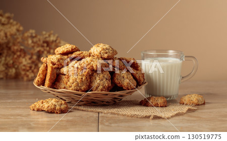 Oatmeal cookies and milk on a kitchen table. 130519775