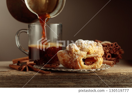 Viennese strudel and black coffee on an old wooden table. 130519777