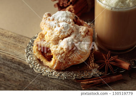 Vienna strudel and caffe latte on a silver tray. 130519779