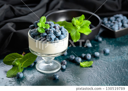 Panna cotta with fresh blueberries in a clear bowl. Panna cotta with fresh blueberries in a clear bowl. 130519789