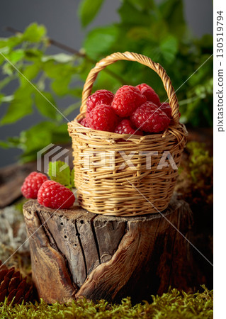 Small wicker basket filled with fresh, ripe raspberries. Small wicker basket filled with fresh, ripe raspberries. 130519794