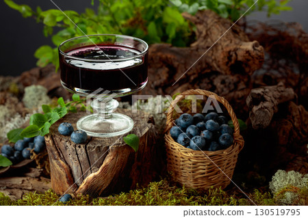 Blueberry jam with fresh berries on an old tree trunk in the forest. 130519795