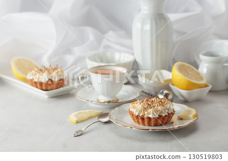 Meringue lemon tart on a white table. Meringue lemon tart on a white table. 130519803
