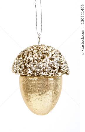 Golden glitter acorn Christmas tree ornament isolated on white background, festive holiday decoration. Golden glitter acorn Christmas tree ornament isolated on white background, festive holiday decoration. 130521496