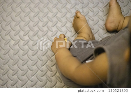 Toddler Holding A Wooden Block In Hand Toddler Holding A Wooden Block In Hand 130521893