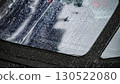 Raindrops on car windows create a blurred reflection of the city street during a rainy afternoon 130522080