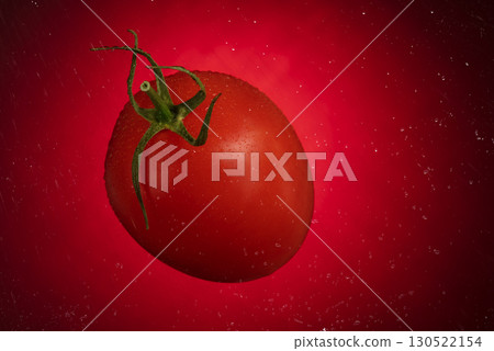 Red tomato with water drops on a red background. Tomato isolated on red background Red tomato with water drops on a red background. Tomato isolated on red background 130522154