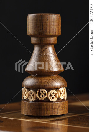 Chess piece of wood black rook. A puzzle game with tricky combinations that requires planning and thinking. Chess piece of wood black rook. A puzzle game with tricky combinations that requires planning and thinking. 130522179