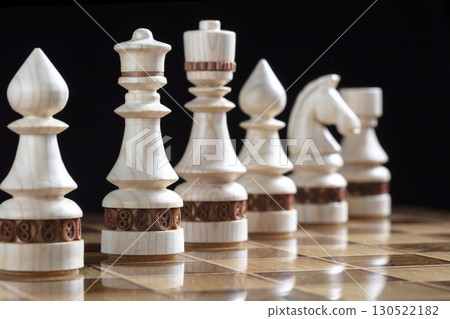 White chess pieces on a chess field. A puzzle game with tricky combinations that requires planning and thinking. 130522182