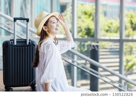 A young woman wearing a straw hat enjoying sightseeing 130522828