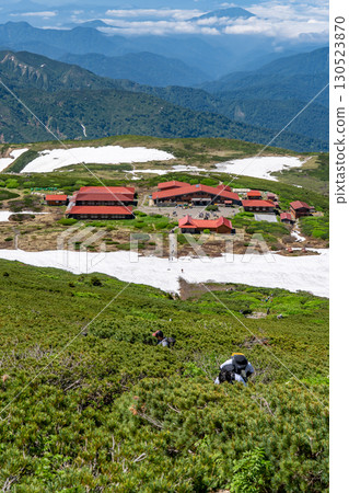 Hakusan Hime Shrine and Murodo Center seen from the Okumiya trail to Mt. Hakusan Gozenmine. Climbing Mt. Hakusan Gozenmine in early summer. Hakusan Hime Shrine and Murodo Center seen from the Okumiya trail to Mt. Hakusan Gozenmine. Climbing Mt. Hakusan Gozenmine in early summer. 130523870