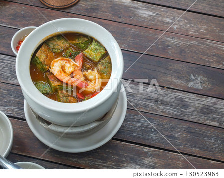 Thai food: Cha-om egg curry with shrimp in a white bowl on a wooden table. Thai food: Cha-om egg curry with shrimp in a white bowl on a wooden table. 130523963