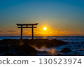 Torii gate floating in the sea and sunrise 130523974