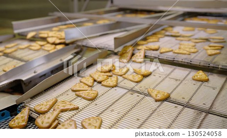 Cookies moving on conveyor belt in food processing plant 130524058