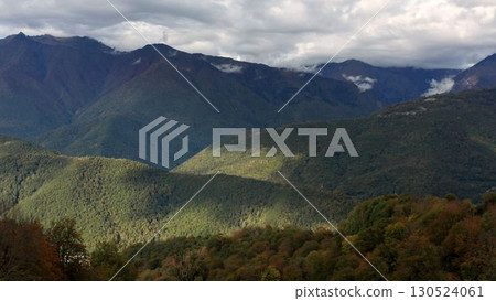 Aerial Drone Footage View: Flight over autumn mountain village with forests, fields and river in sunrise soft light. Beautiful mountains in autumn. Beauty world. 4K 130524061