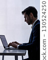Businessman with laptop and virtual interface 130524250