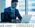 Businessman with laptop and virtual interface 130524252