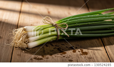 Fresh Bundle of Welsh Onions on Wooden Table 130524285