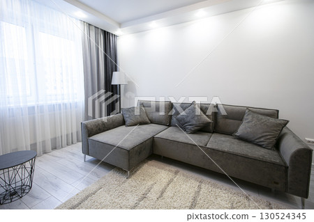 Part of the room interior with a gray corner sofa. 130524345