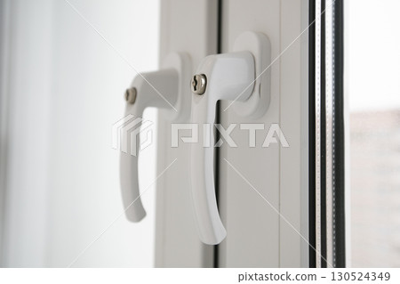 White plastic window handle. Open the window. White plastic window handle. Open the window. 130524349