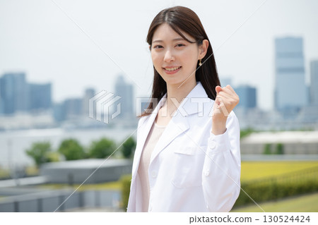 A woman in a white coat 130524424