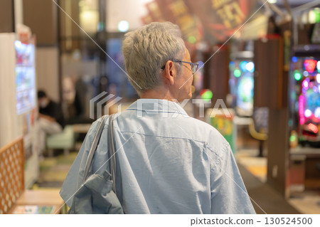 Senior man entering a pachinko parlor 130524500