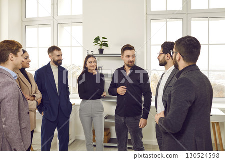 Group of business people chatting after a meeting. Company employees talking in the office. Group of business people chatting after a meeting. Company employees talking in the office. 130524598