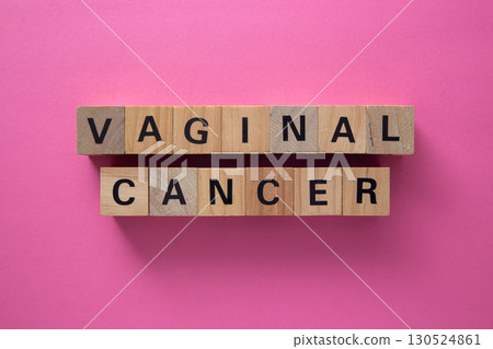 Vaginal cancer awareness message with wooden cubes on pink background 130524861