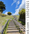 A child climbing wooden stairs under the blue sky 130525021