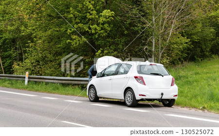 Broken car with open hood on the side of the highway Broken car with open hood on the side of the highway 130525072