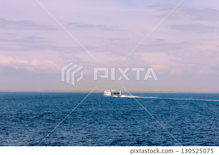 Seascape with a white ferry in the distance and waves. Seascape with a white ferry in the distance and waves. 130525075