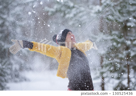 Blurred happy middle aged woman throws snow. Blurred happy middle aged woman throws snow. 130525436
