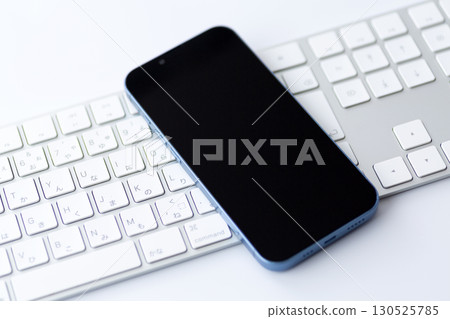 White computer keyboard and smartphone 130525785