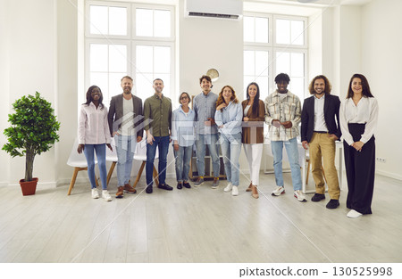 Diverse team of happy smiling business people standing together at work in the office 130525998