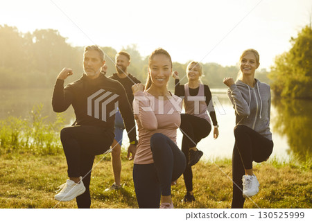 Group of fit and active people doing sport exercising in nature. Outdoors fitness concept. 130525999