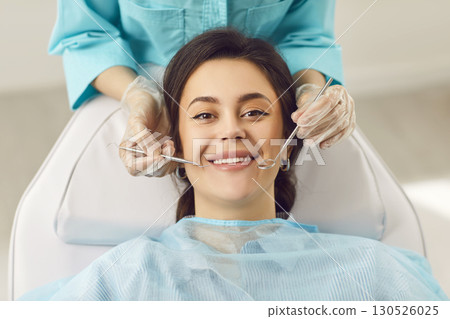 Dentist exam, teeth, gums, dental care exam, happy smiling woman healthy smile at doctor visit  130526025