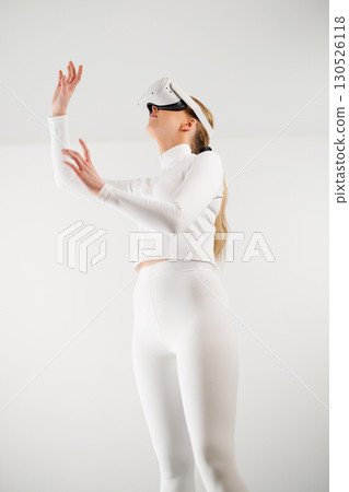 Woman in VR glasses shopping in studio Woman in VR glasses shopping in studio 130526118