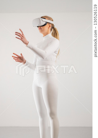 Woman Using Virtual Reality Headset Woman Using Virtual Reality Headset 130526119