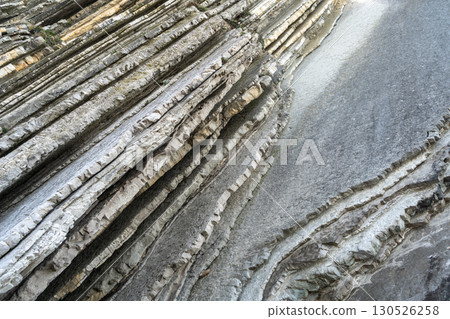 Layered rocks, flysch texture background. Sedimentary rock, striations stone pattern 130526258