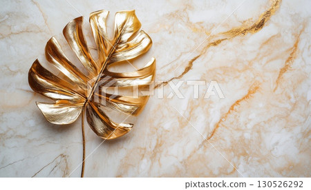 Luxurious Golden Monstera Leaf On Marble 130526292