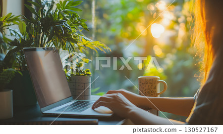 Freelancer working remotely from home with a relaxed and productive setup. Ideal for blogs, tech services, and work-from-home promotions. 130527167